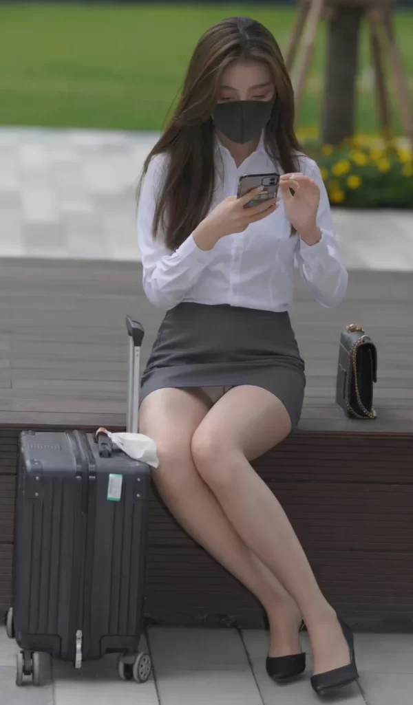 屋外のベンチに座ってタイトミニから股間の白パンティをパンチラさせるOL